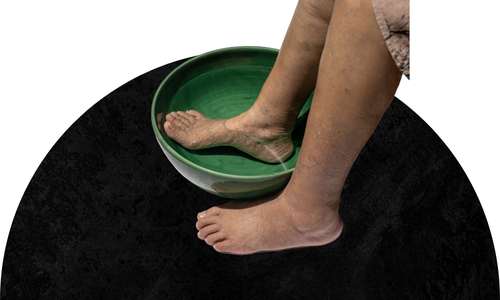 woman soaking feet in water